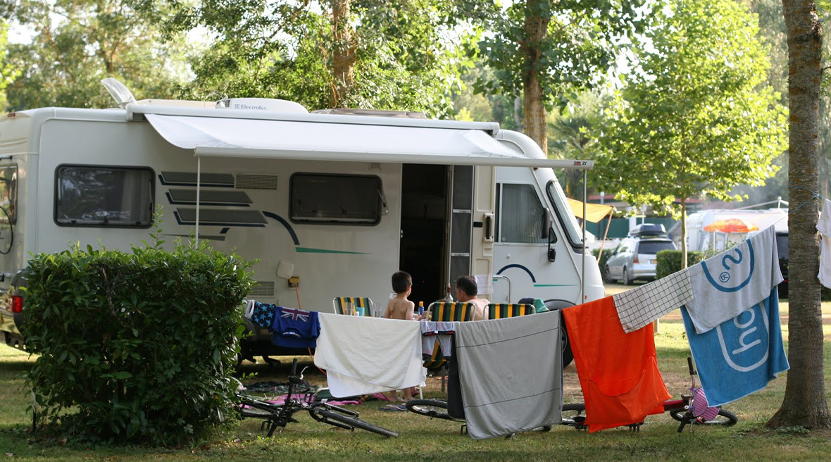 A family motorhome on a campsite, made untidy by family life